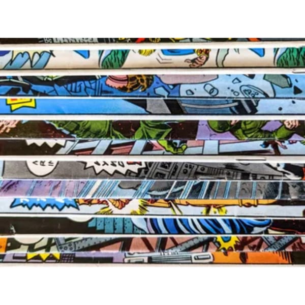 Close-up of the spines of multiple comic books, showcasing colorful illustrations and text.